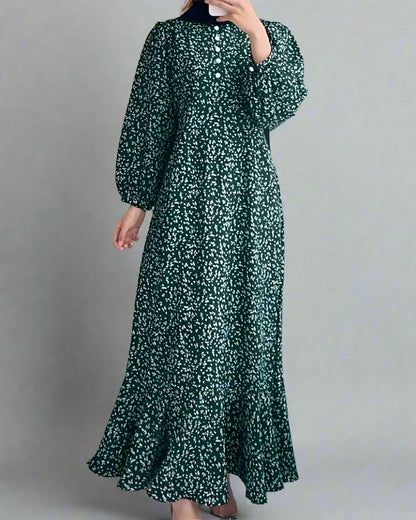 Green floral dress worn by a person in a minimalistic room.