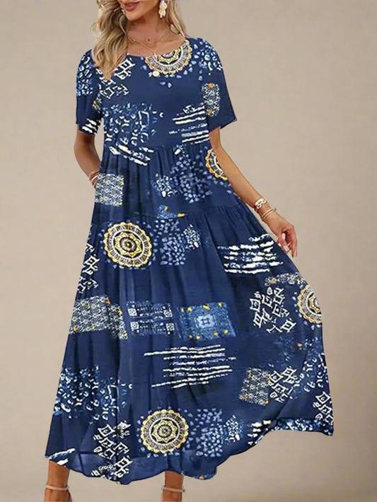 Woman wearing a blue dress with gold and white patterns on a white background